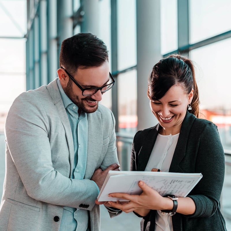 Man and Woman Looking over Finances